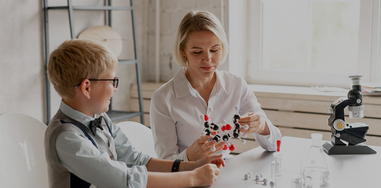 Female science tutor in Tucson studying chemistry with student