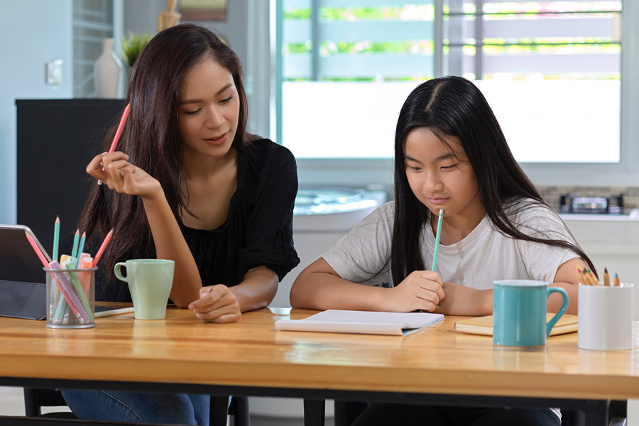 student and tutor together at a desk in Tucson